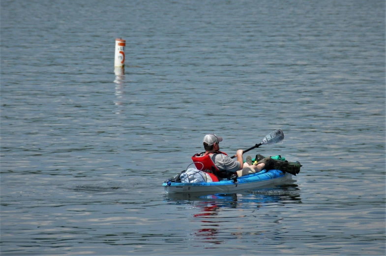 two people are paddling in a kayak on a lake