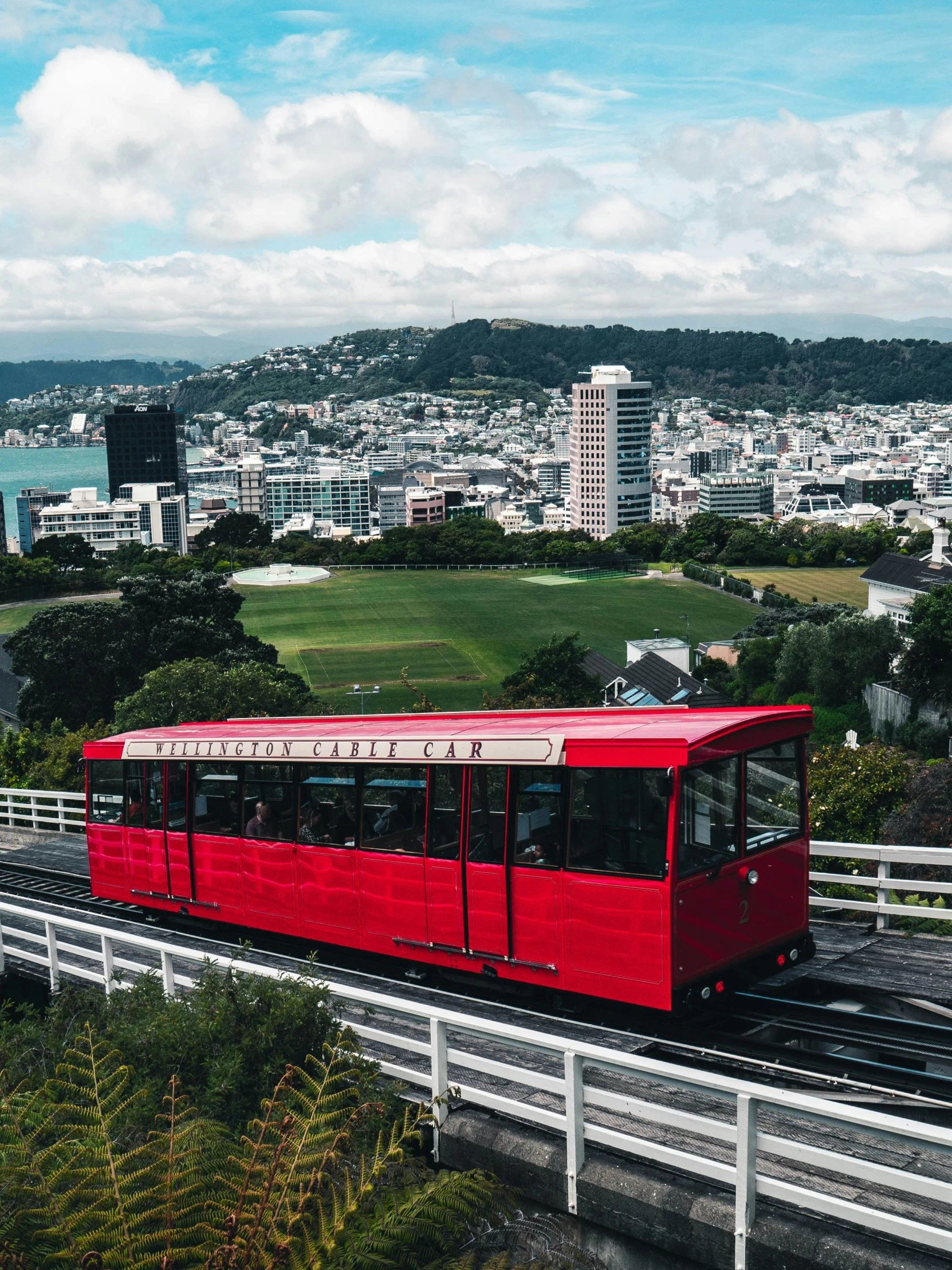 a red train is riding down the tracks