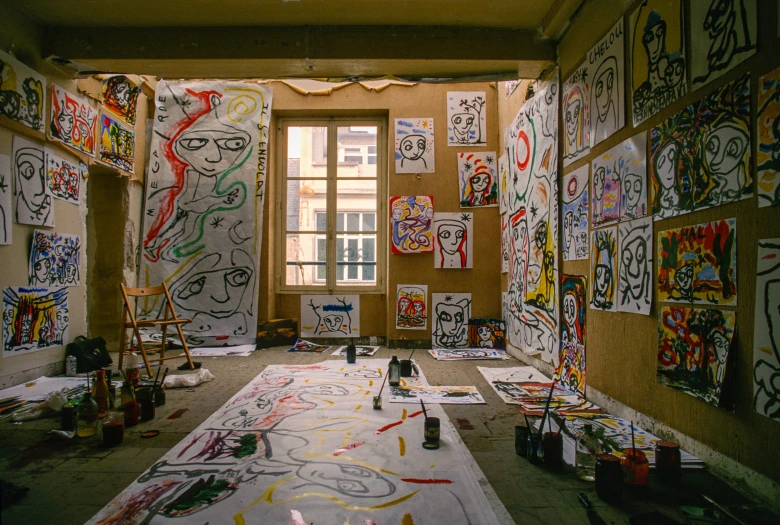 art is on the walls and a floor in an artistic room