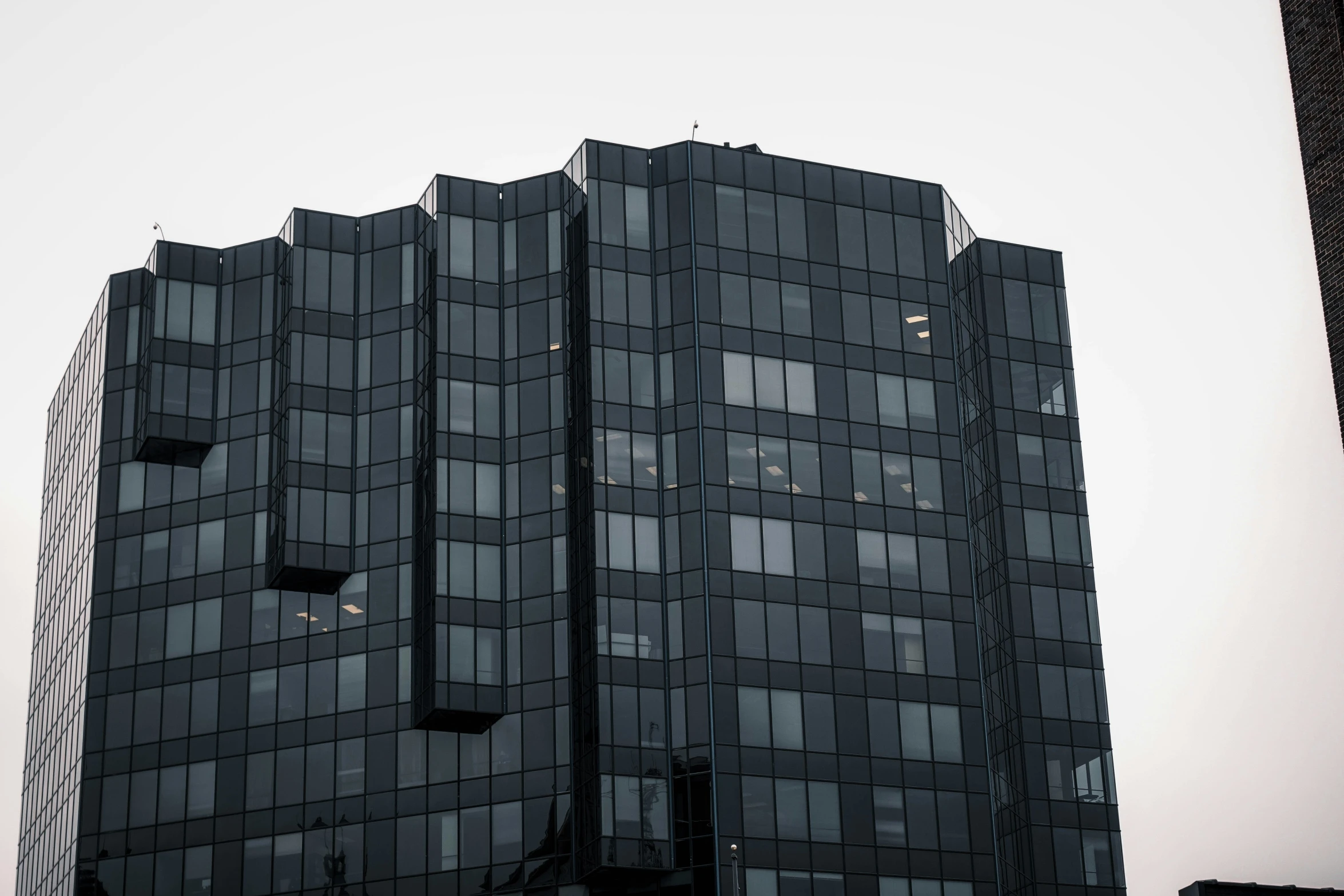 black windows on a high rise building at dusk