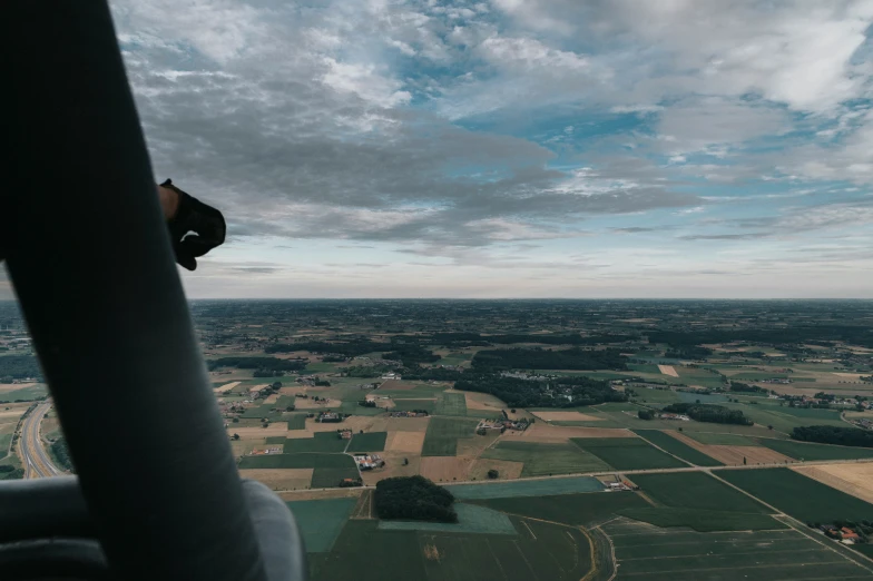 a view out the window of an airplane over a field