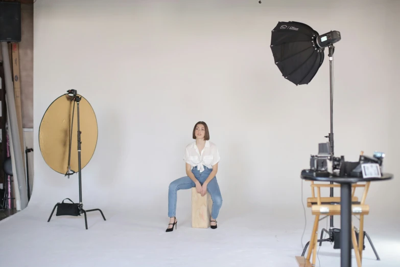 a po studio with a woman sitting in a chair