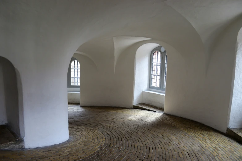 this is an empty room with two arched windows