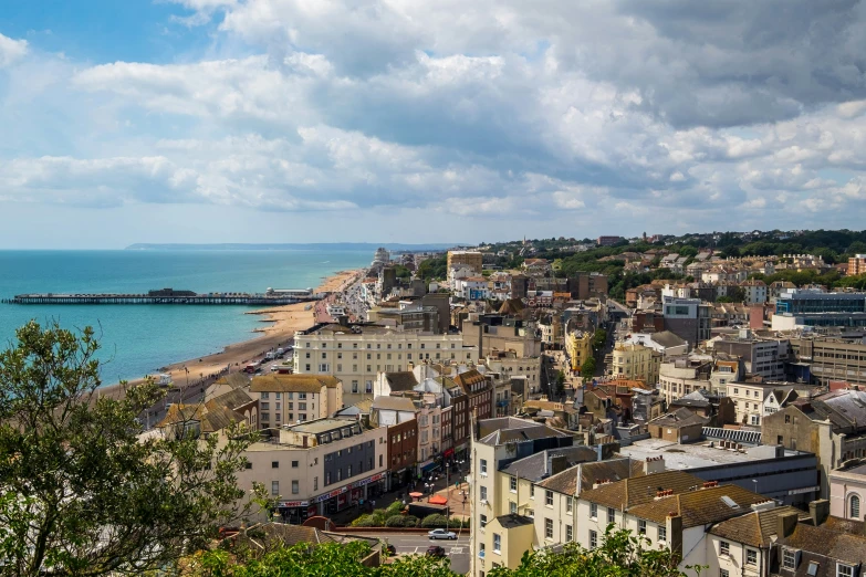 a large city by the sea under a cloudy sky