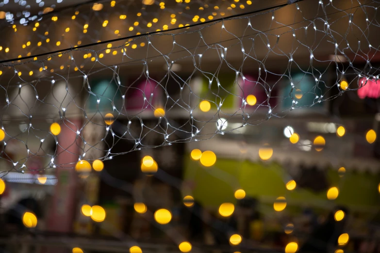 many bright balls are floating on strings that are hung above