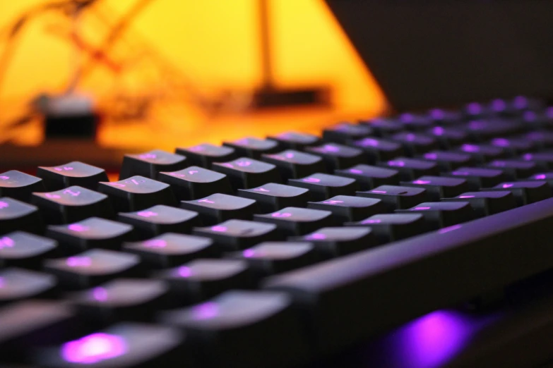 closeup s of keyboard with lights in dark room