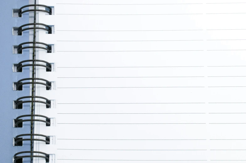 an open spiral bound notebook with white writing on it