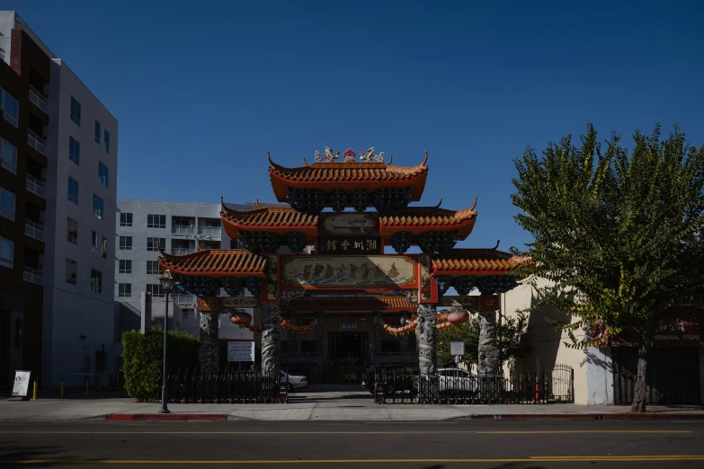 a tall asian building with lots of red roofs