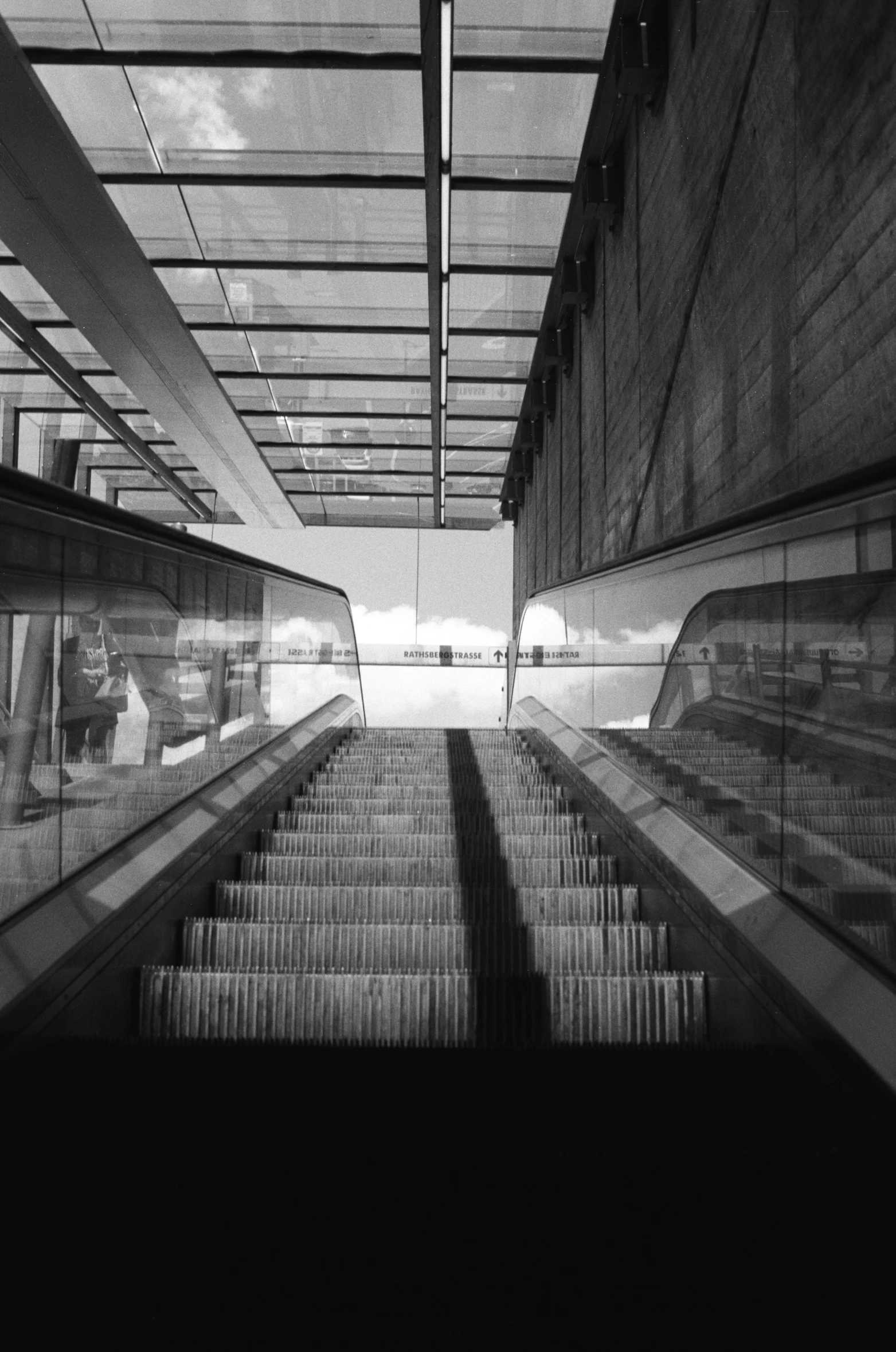 an escalator with rows of empty chairs between them