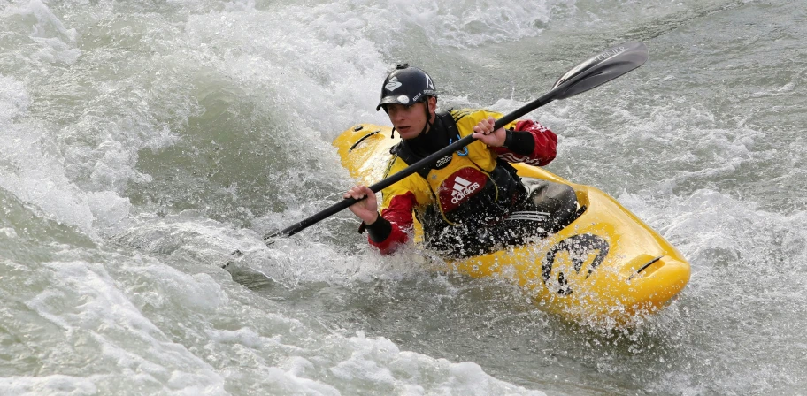 a man riding on the back of a kayak