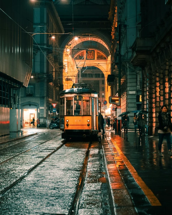 people standing on a sidewalk near a streetcar