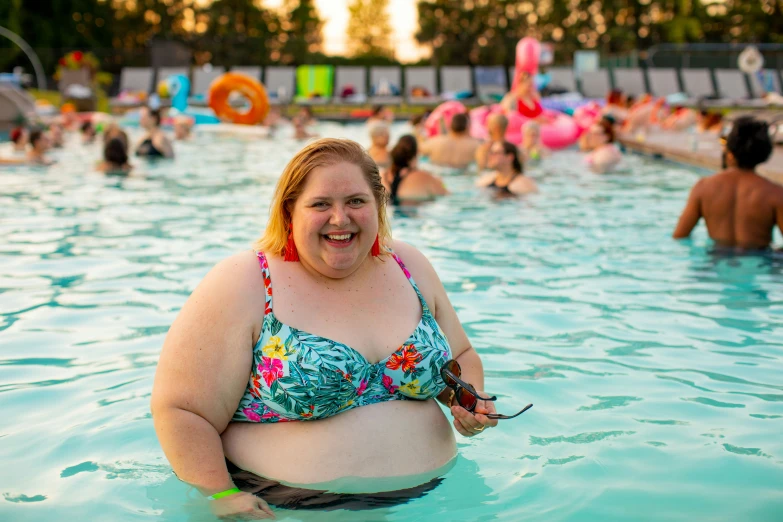 a woman smiles while sitting in a pool