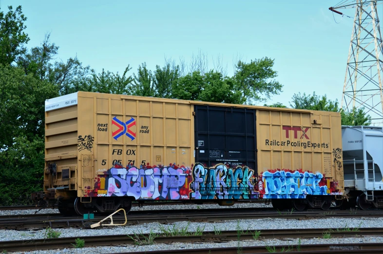 an old train with graffiti on the side of it