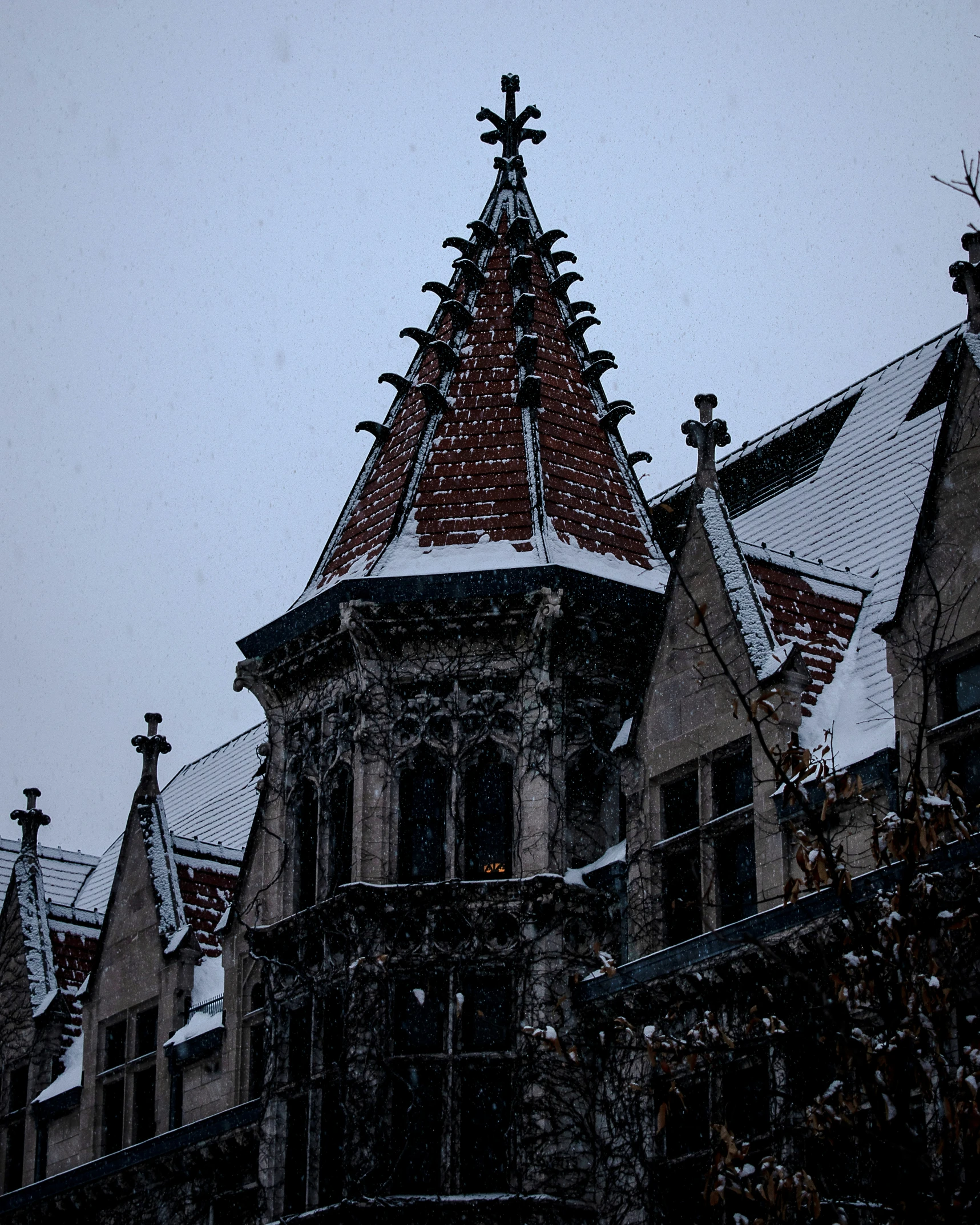 a building with a steeple and snow on the roof