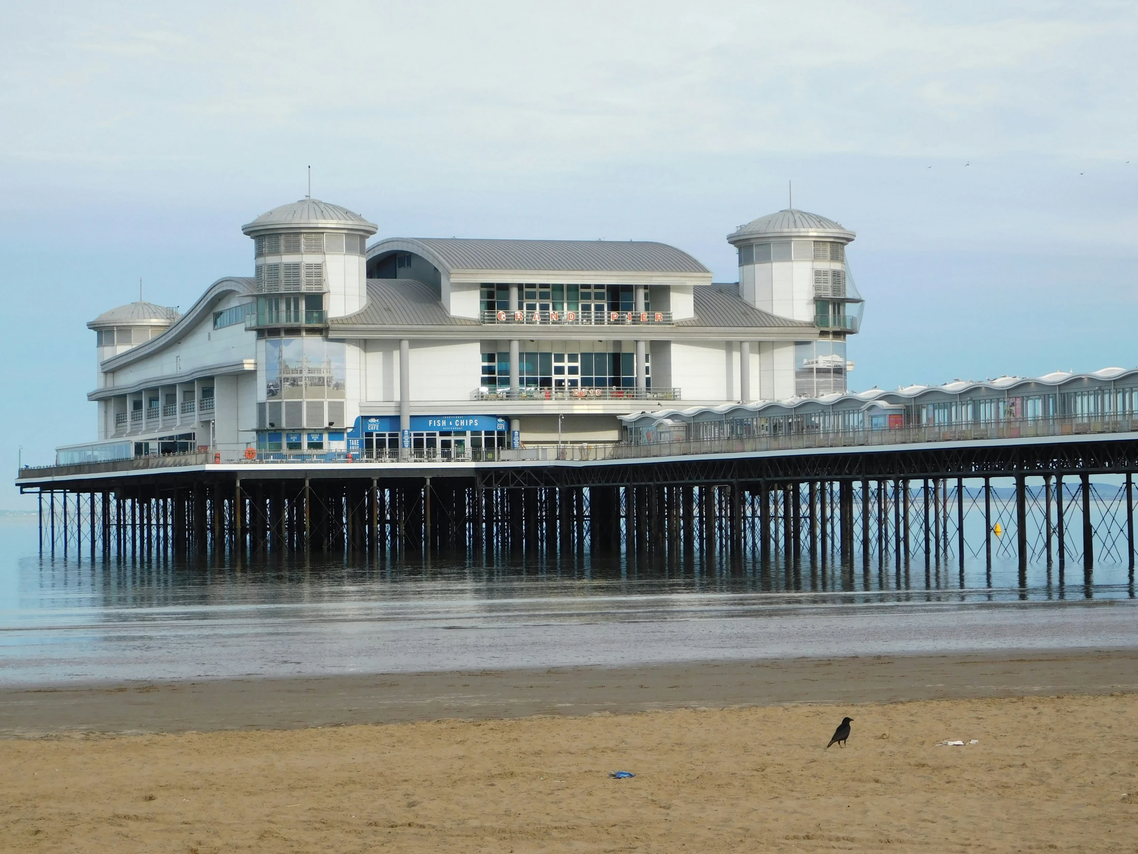 the pier and buildings in front of the ocean