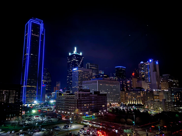 a city at night with skyscrs in the background