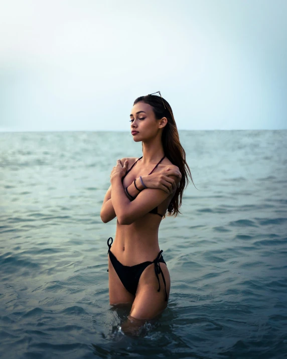 woman wearing a bikini standing in the water