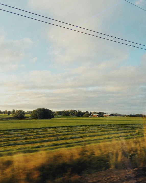 a view from a moving train window of the field