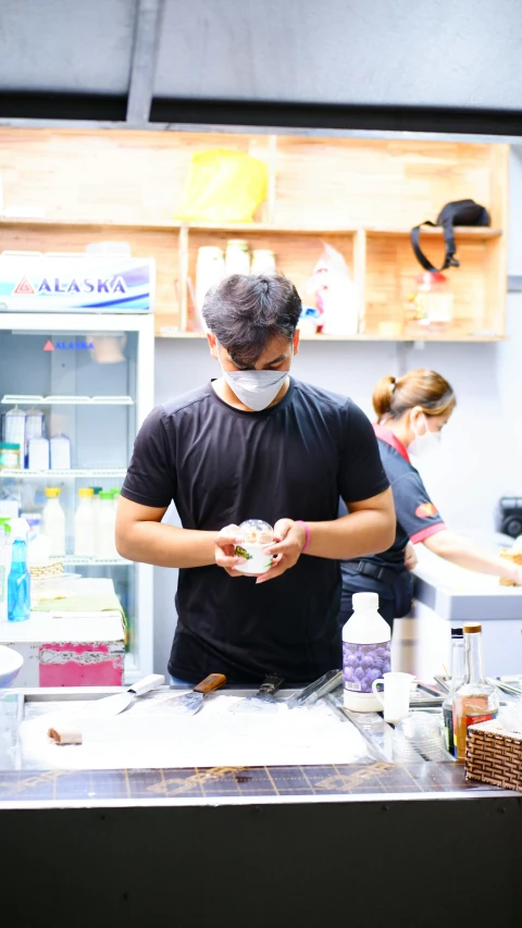 a man that is standing at a counter