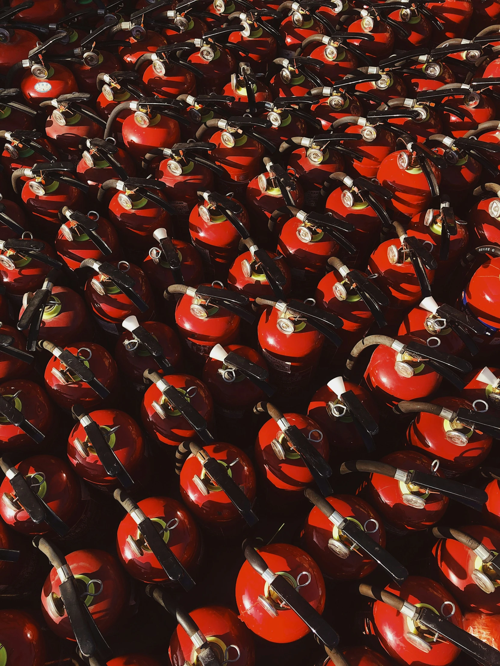 rows of red and black fire hydrants are shown in a pattern