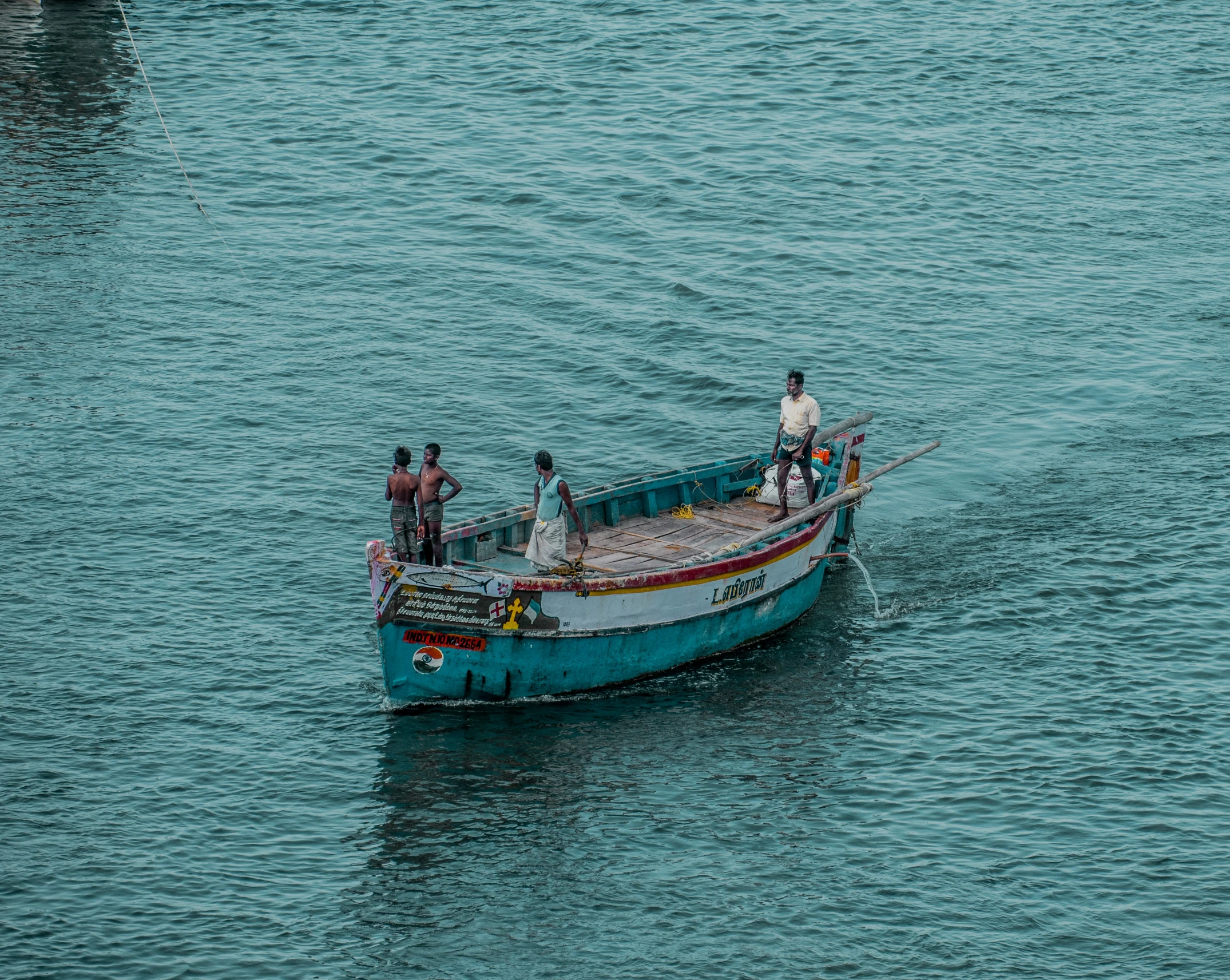 four men in boat on the water with their dogs