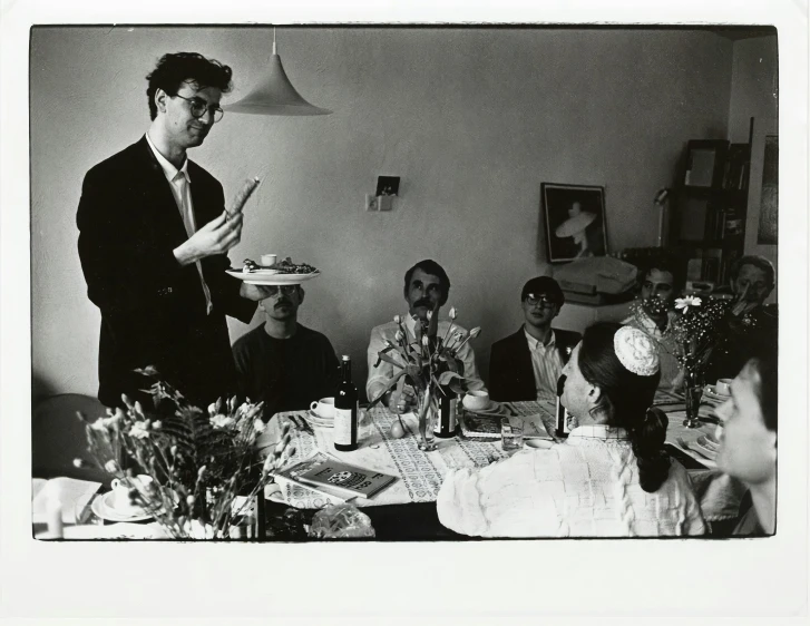 a group of people sitting at a table eating food