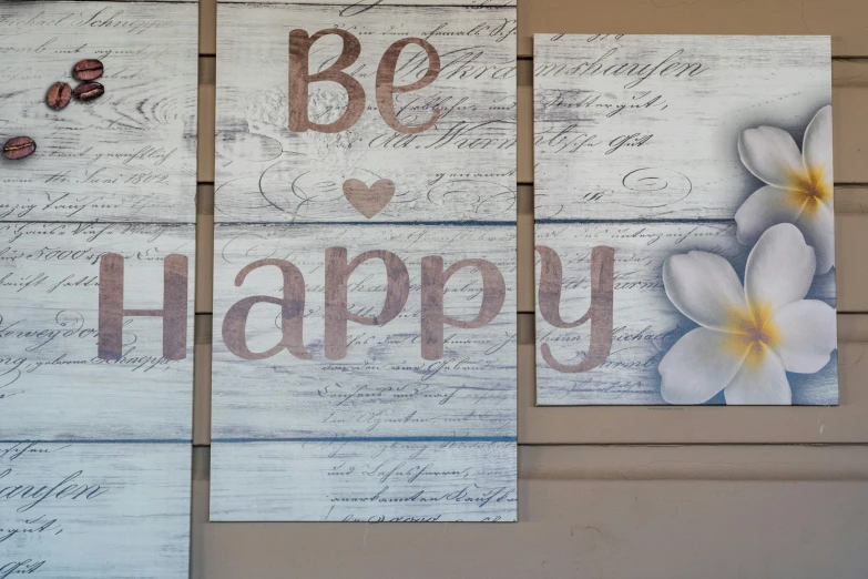 three wooden signs, two are handmade with white and brown paint and the other has been made with wood