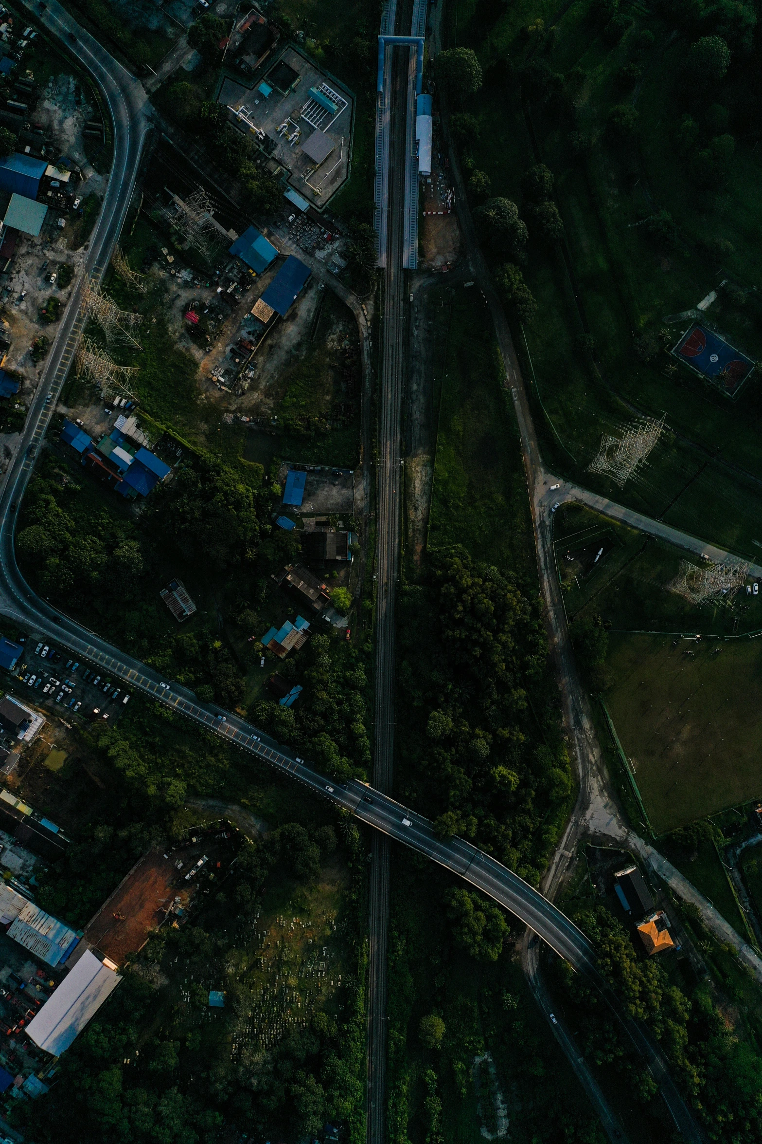 an aerial view shows a road intersection in a wooded area