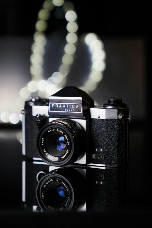 a camera with a long lens sits near a display of lights