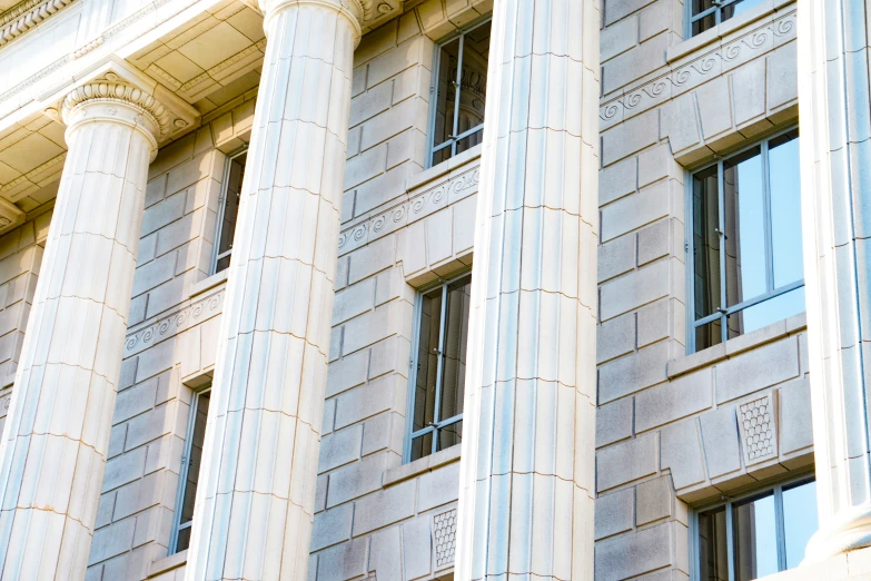 a tall building with several windows and pillars