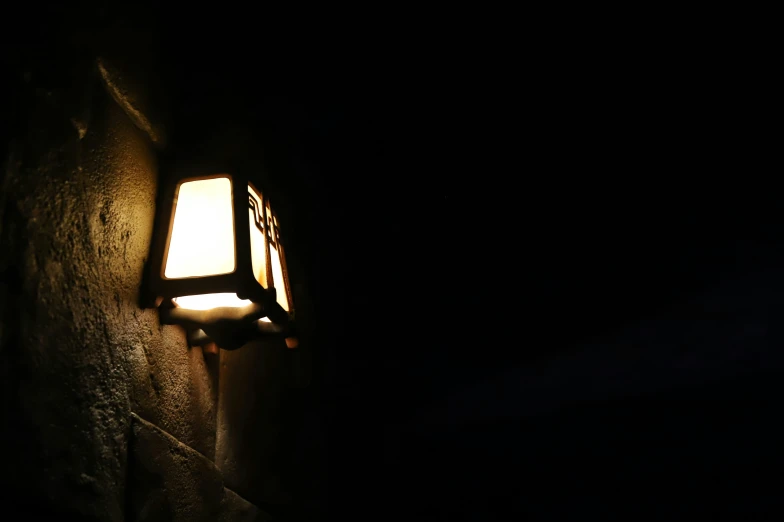 a street lamp with the light on from a cave