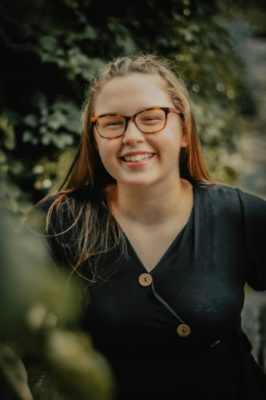 a woman wearing glasses posing for a picture