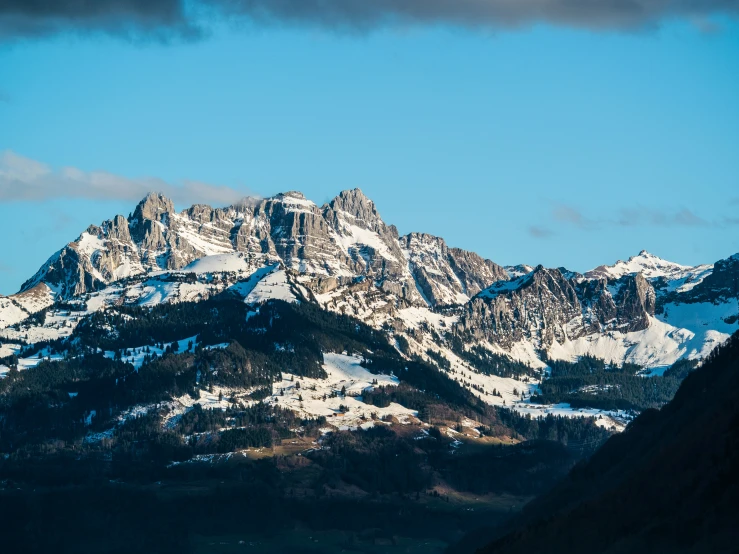 snowy mountains can be seen against the blue sky