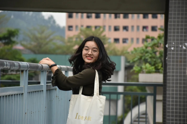 a woman in glasses holds onto a white bag