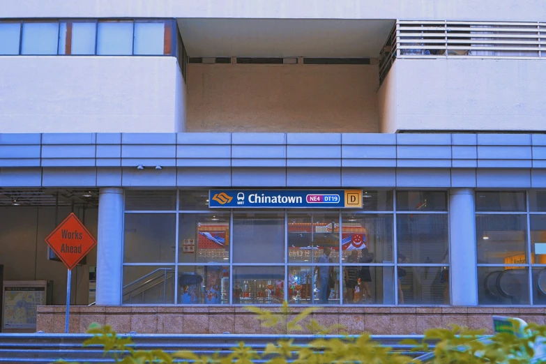 a storefront with the doors open near two benches