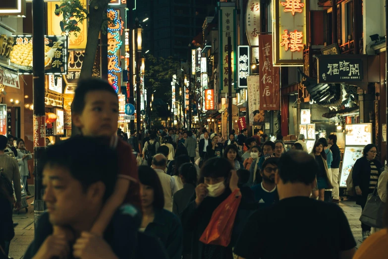 a very crowded city street at night time