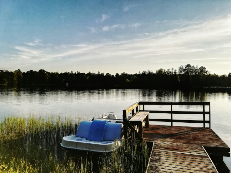 a boat is docked at the edge of a body of water