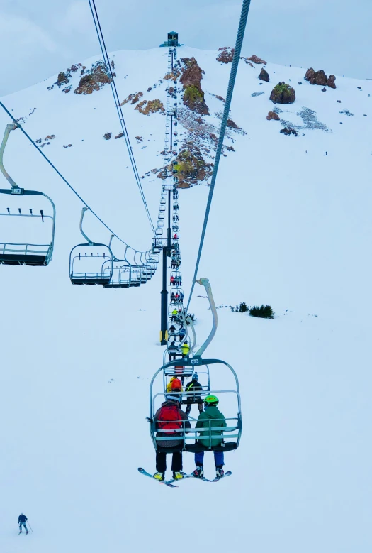 people at the bottom of the gondola on a ski lift