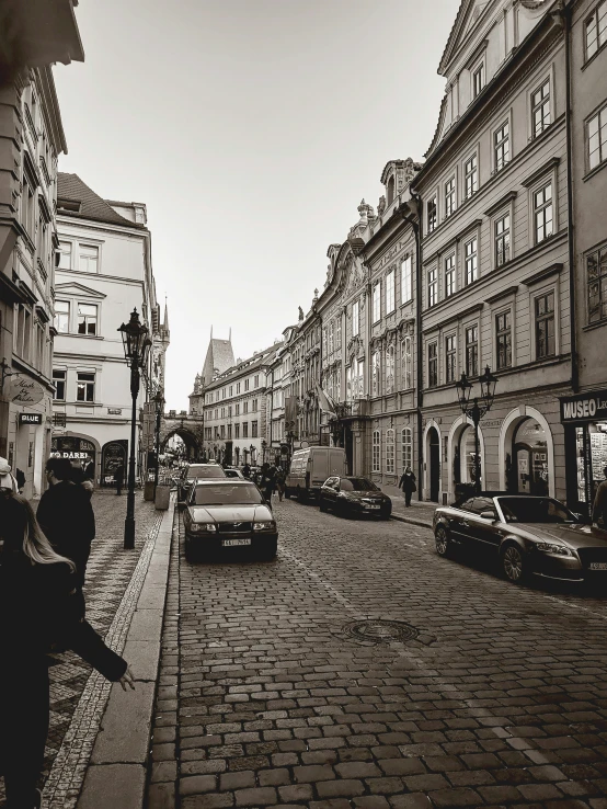 an empty street surrounded by tall, old buildings