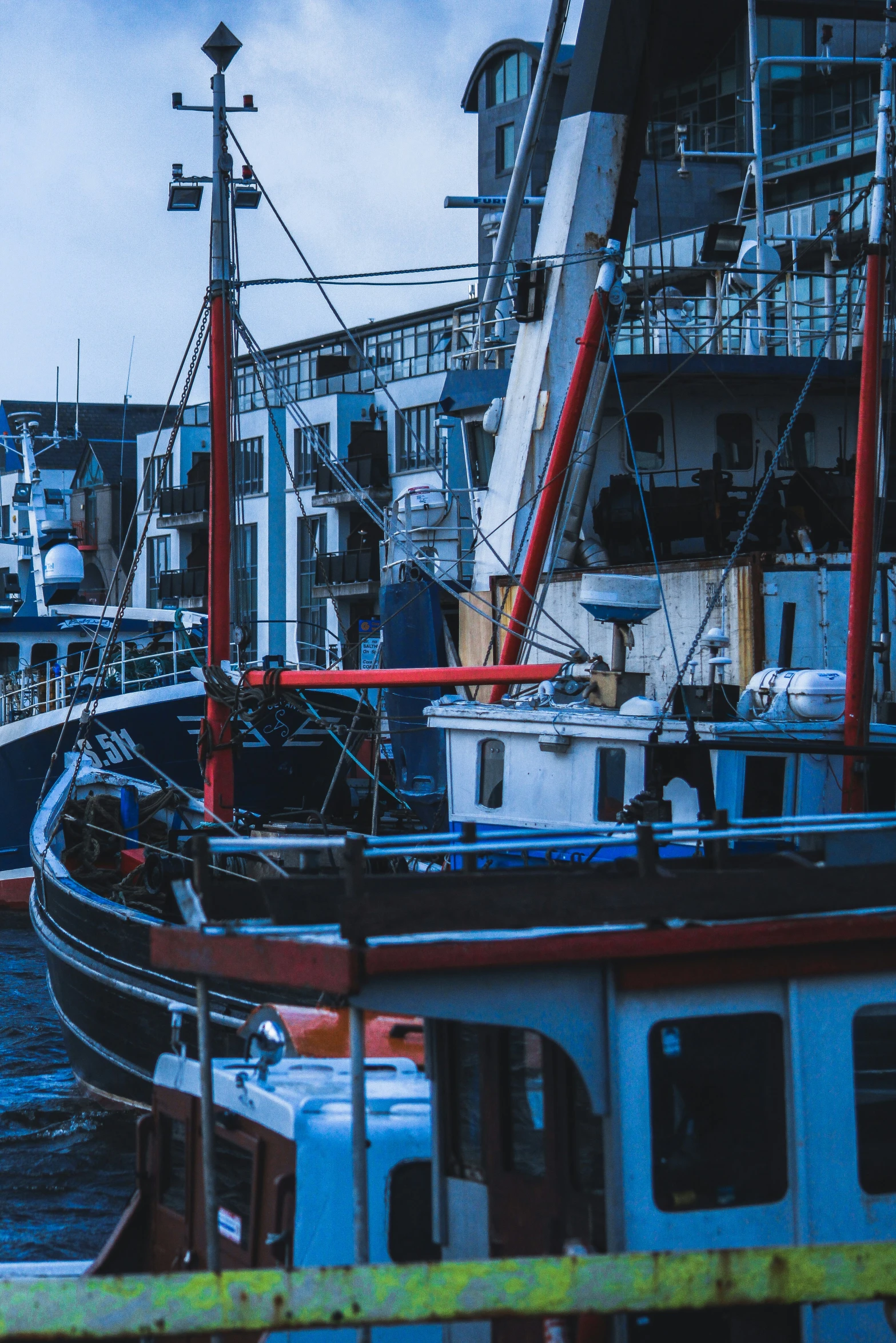 large and small boats are in the harbor