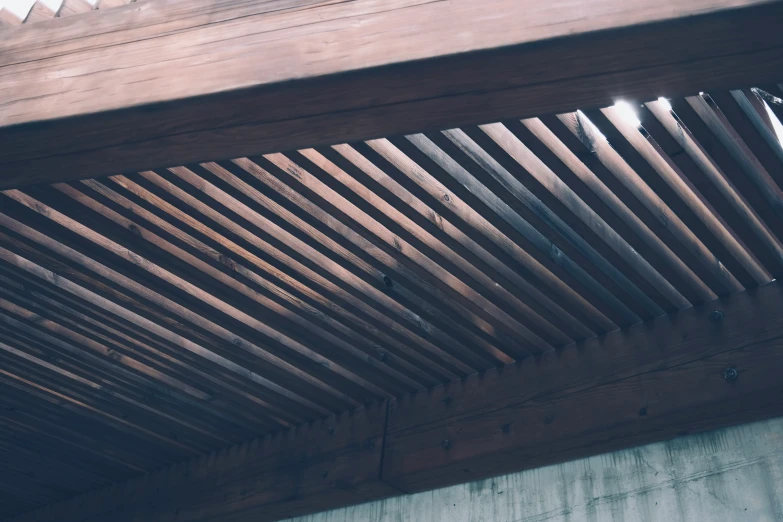 a wooden structure has a closed roof made of thin wood slats