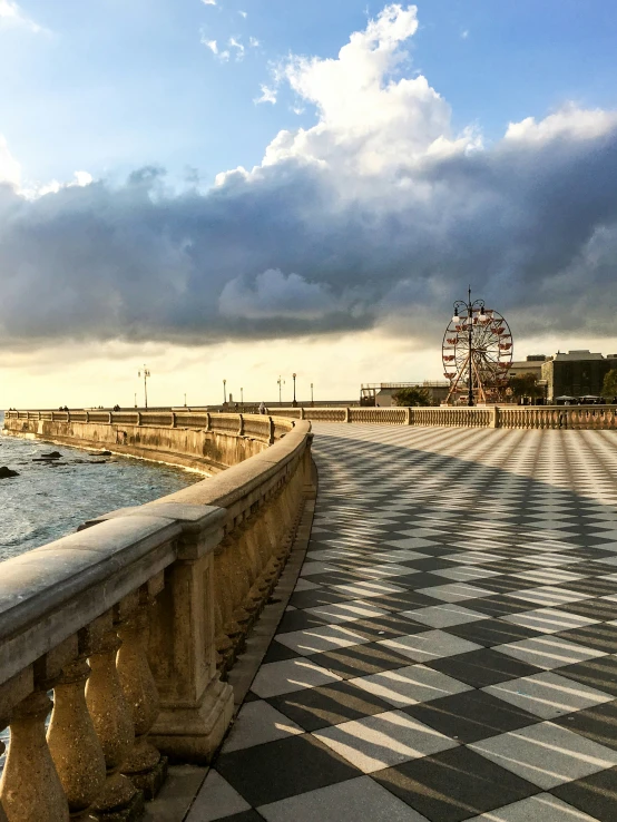 a long walkway is shown in front of the ocean