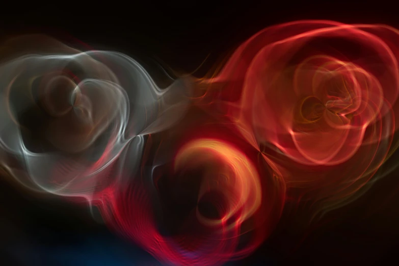 three circular abstract lights in motion on a black background
