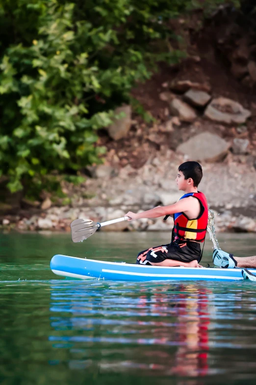 a man riding a surf board on top of a lake