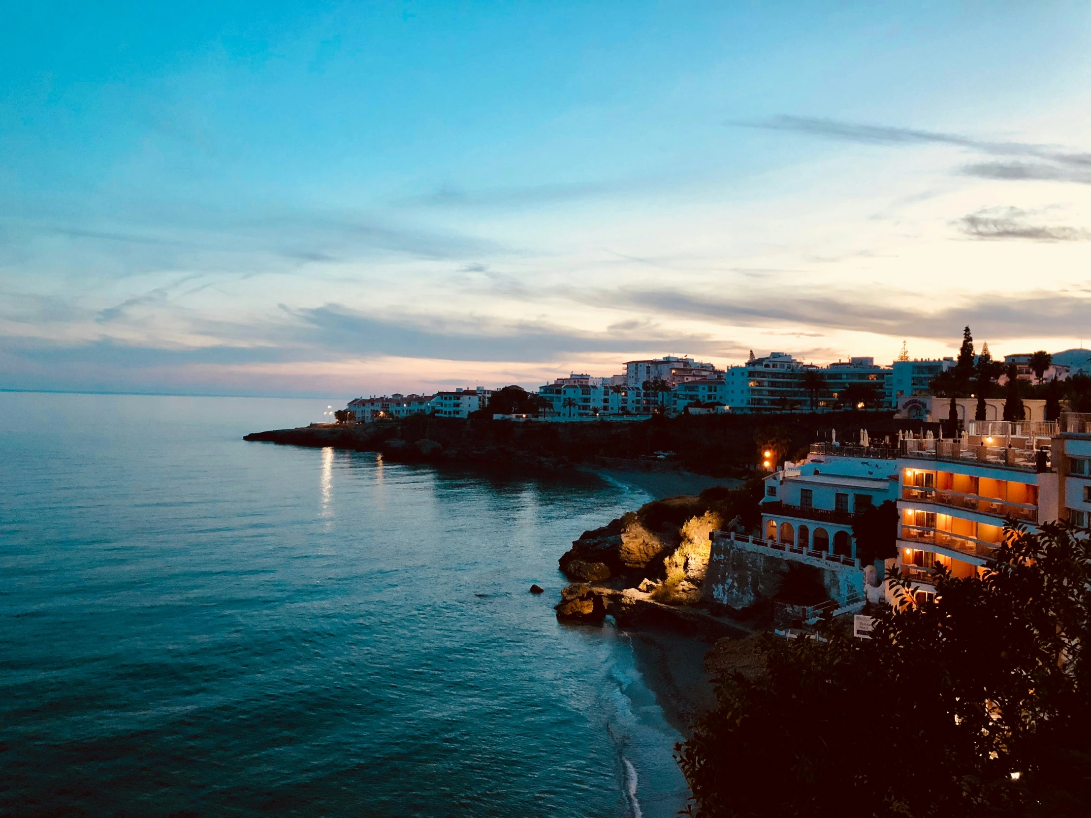 the blue water has a night time view of the ocean