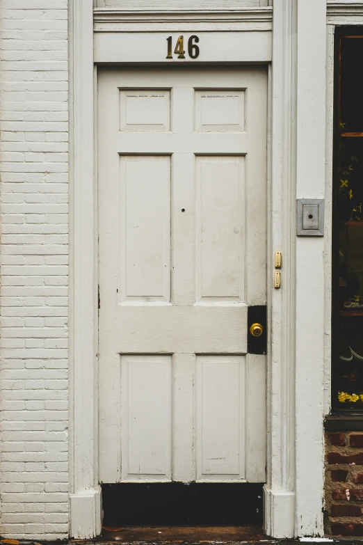 an old brick building has two doors and an iron weather guard