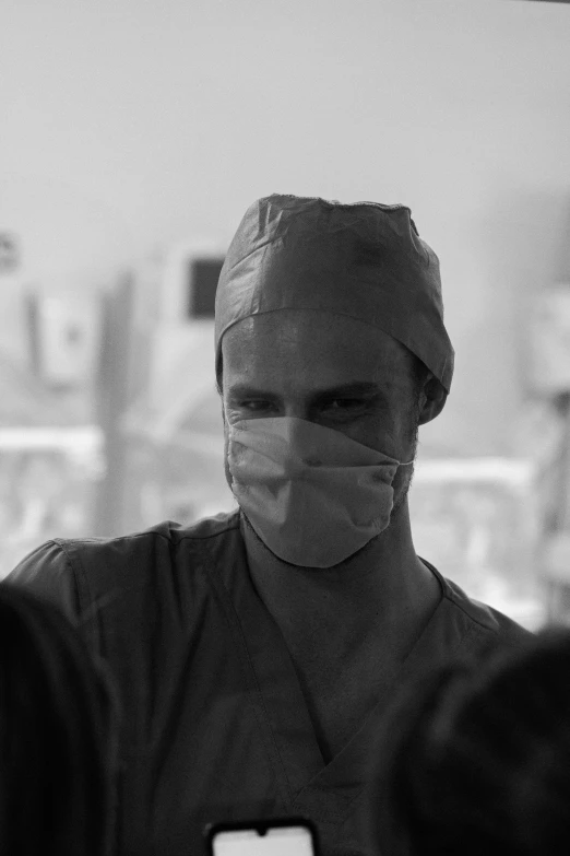 a man in scrubs wearing a face mask