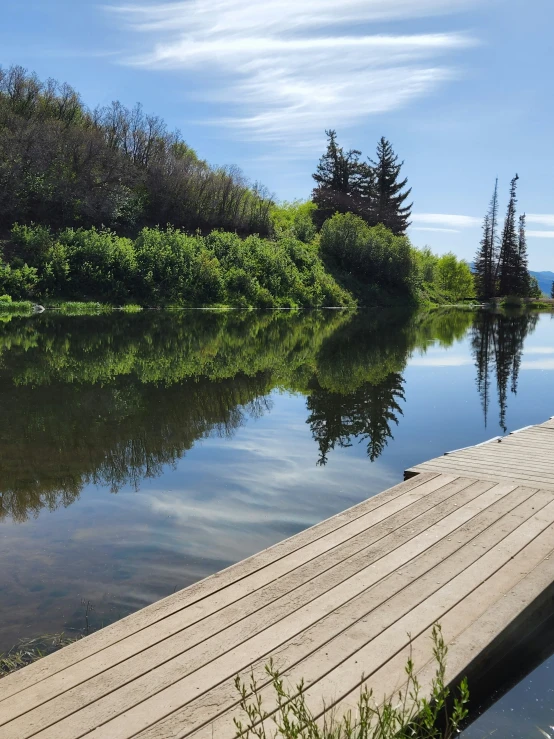 a wooden dock leading to a water way