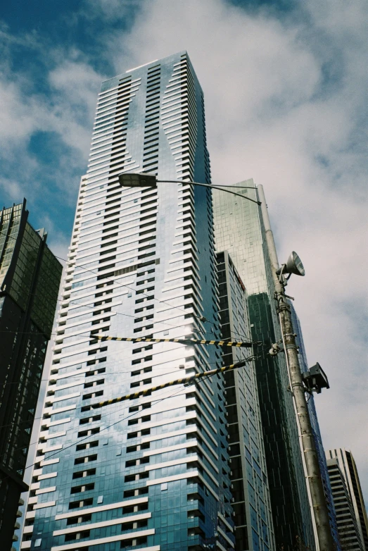 a tall skyscr sits with a street light below