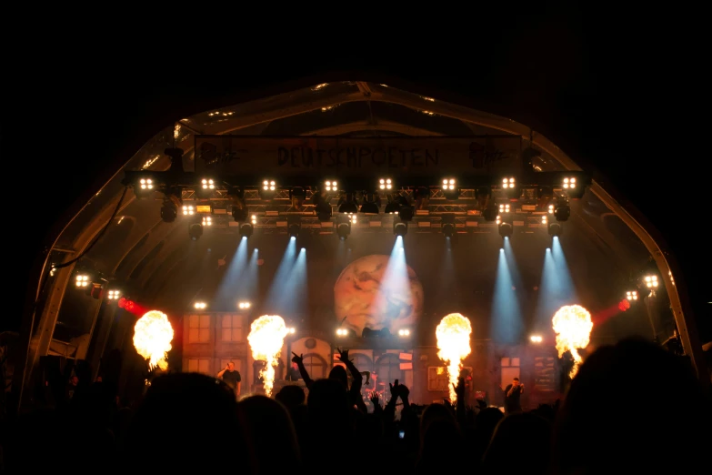 a group of people in front of a stage on a black background